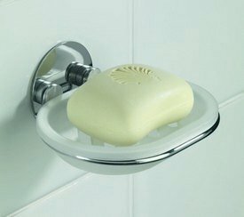 translucent white soap dish held by a chrome holder, in the soap dish is a white bar of soap.