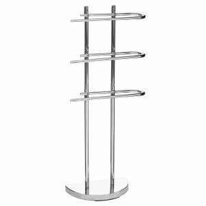 chrome toilet brush holder with a circular wall plate with an indented circular pattern holding a white ceramic tumbler from near the the top holding a white ceramic holder containing a white and chrome toilet brush